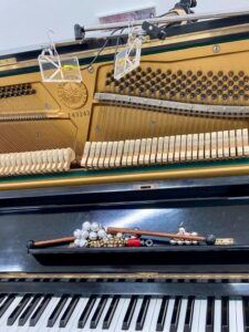 mallets, bells on piano music rack; up above them BAROｍ1 microphone set on the piano